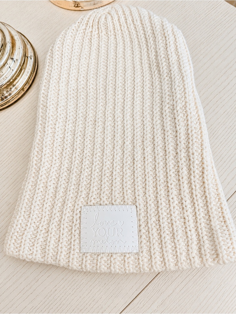 Love Your Melon Cream Cable Knit Beanie with White Logo Patch